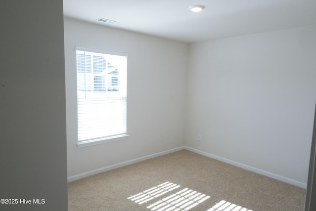 unfurnished room with light colored carpet