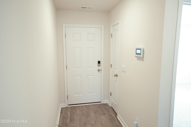 corridor with light wood-type flooring