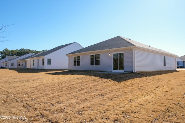 back of property with a lawn