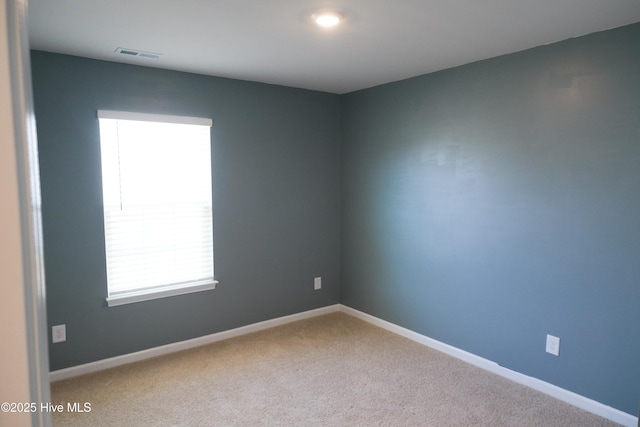 carpeted spare room with plenty of natural light