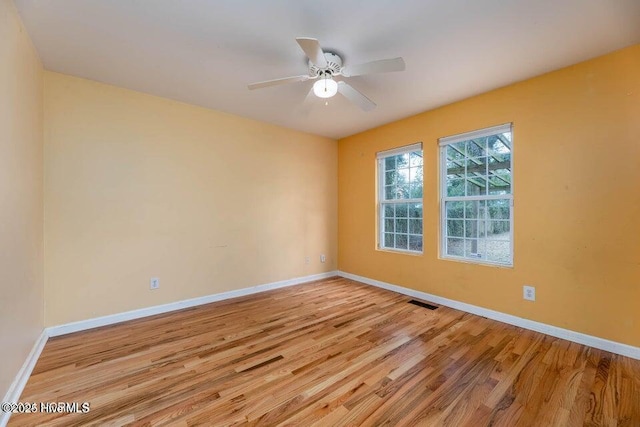 spare room featuring ceiling fan and light hardwood / wood-style floors