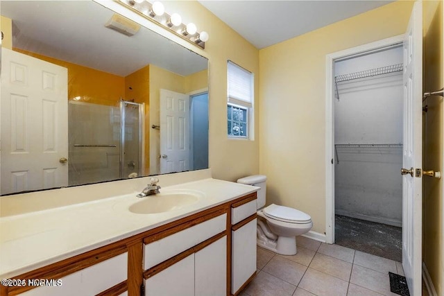 bathroom with vanity, toilet, an enclosed shower, and tile patterned flooring