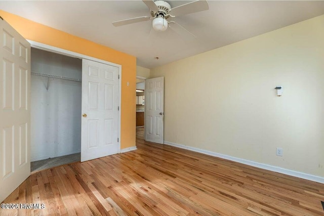 unfurnished bedroom with ceiling fan, a closet, and light hardwood / wood-style flooring