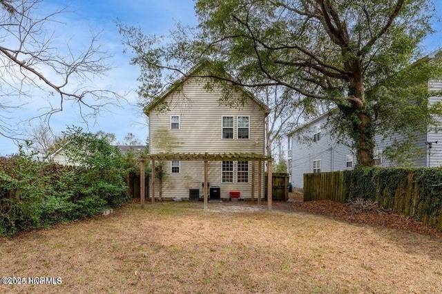 rear view of house with a lawn