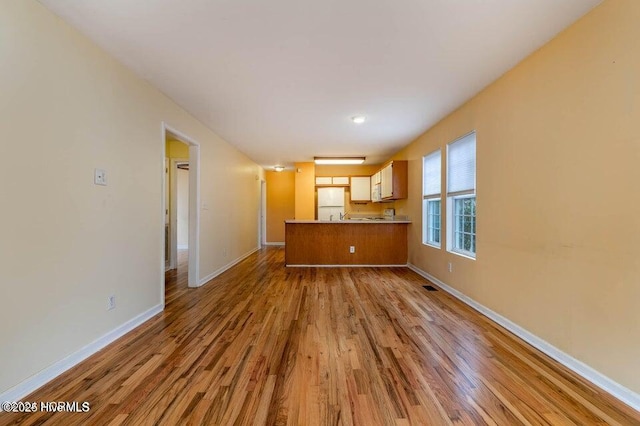 unfurnished living room featuring light hardwood / wood-style floors