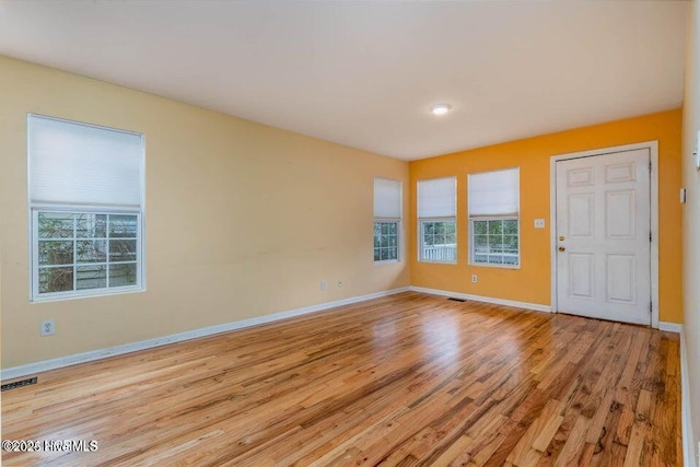 empty room with a healthy amount of sunlight and light wood-type flooring