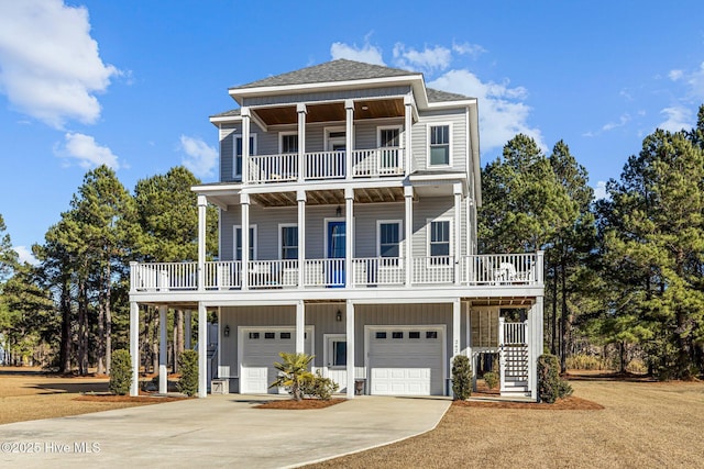 raised beach house with a garage, a balcony, and covered porch