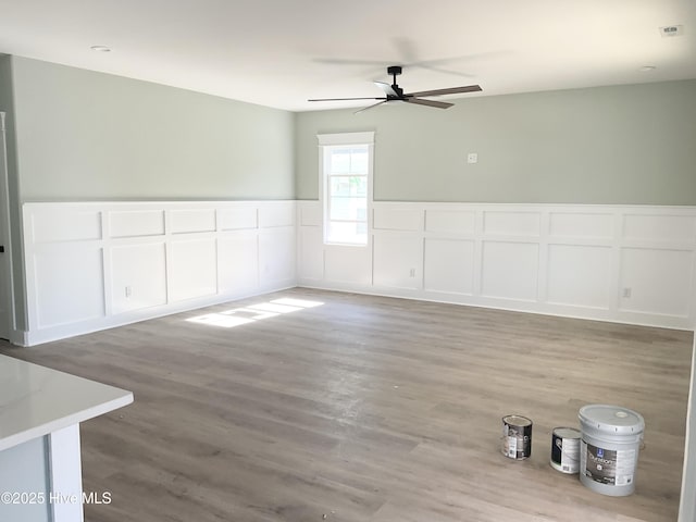 empty room featuring hardwood / wood-style floors and ceiling fan