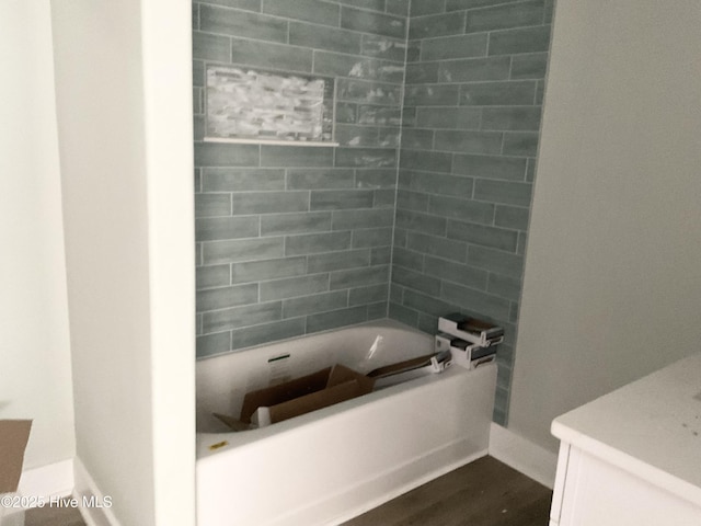 bathroom featuring tiled shower / bath combo and hardwood / wood-style floors