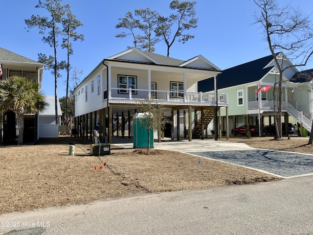 coastal home featuring a carport and a porch