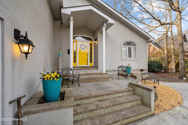 property entrance with stucco siding