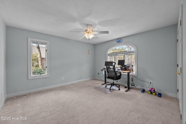 office with ceiling fan, light carpet, and a textured ceiling