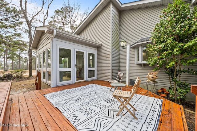 wooden terrace with a sunroom