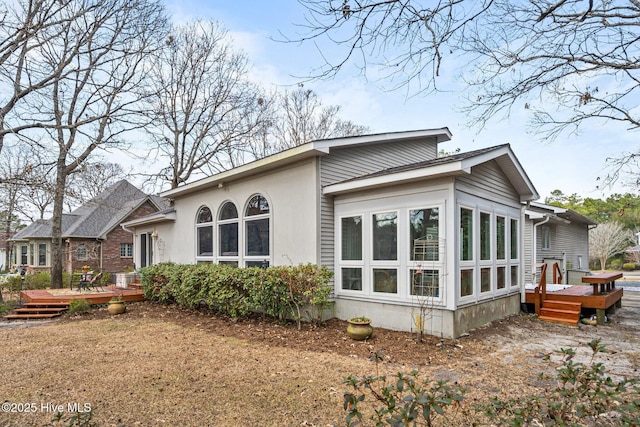 back of house with a wooden deck