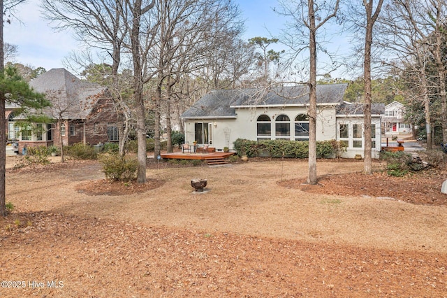 rear view of house with a wooden deck