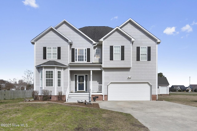 traditional-style house featuring driveway, a garage, a shingled roof, fence, and a front yard