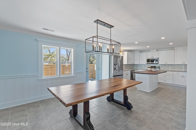 dining area featuring crown molding