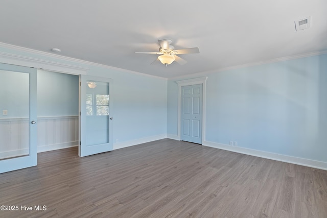 spare room with crown molding, light hardwood / wood-style floors, and ceiling fan