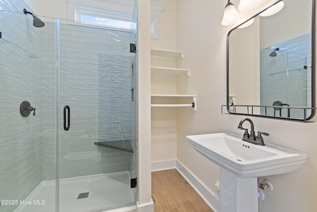 bathroom with sink, hardwood / wood-style floors, and walk in shower