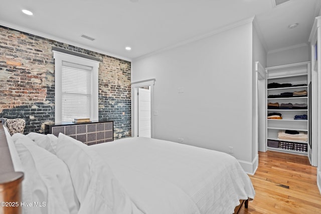 bedroom featuring ornamental molding and hardwood / wood-style floors