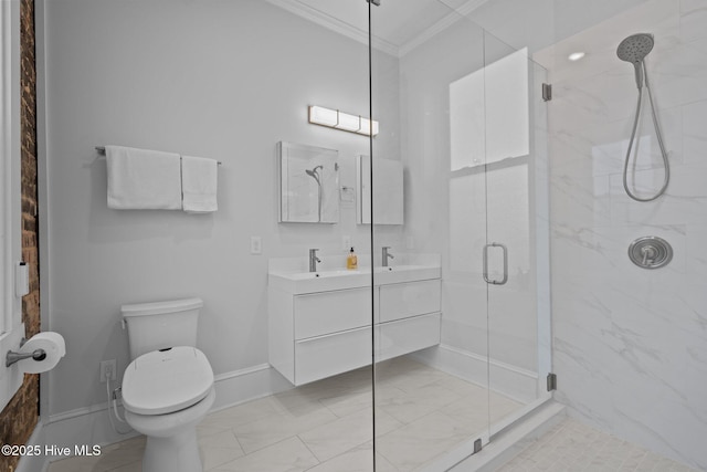 bathroom with vanity, crown molding, a shower with door, and toilet