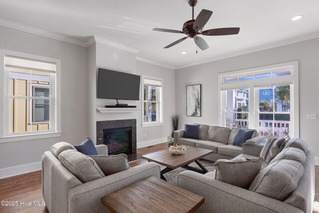 living room featuring crown molding, plenty of natural light, and hardwood / wood-style floors