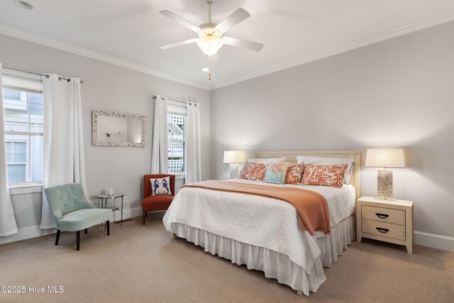 carpeted bedroom with crown molding and ceiling fan