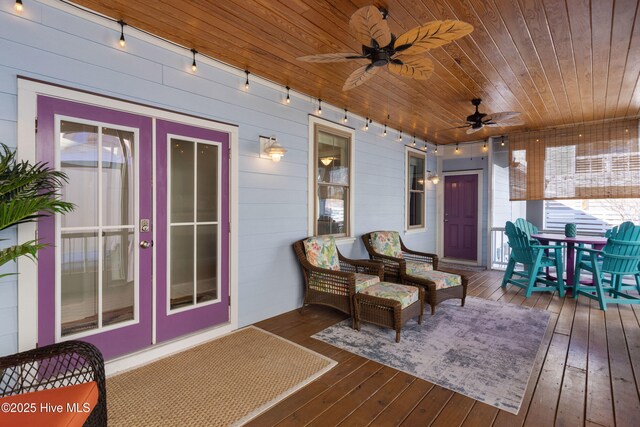 wooden deck with ceiling fan and french doors