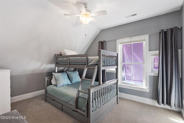 carpeted bedroom with lofted ceiling and ceiling fan