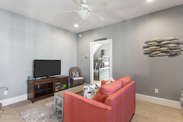 carpeted living room featuring ceiling fan