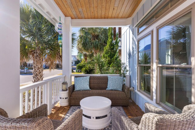 sunroom / solarium featuring wood ceiling