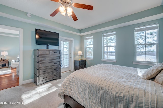 bedroom featuring light carpet, ceiling fan, access to exterior, and baseboards