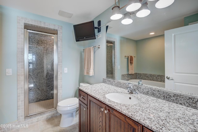 bathroom featuring toilet, a stall shower, tile patterned flooring, and vanity