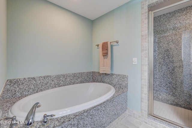 bathroom with a shower stall and a bath