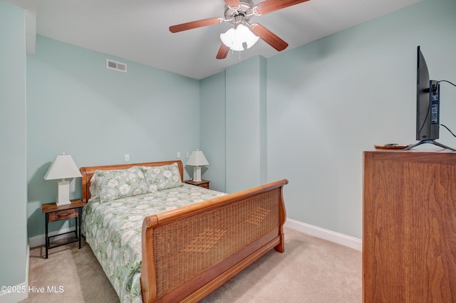 bedroom featuring a ceiling fan, light colored carpet, visible vents, and baseboards