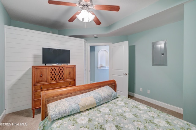 bedroom featuring carpet floors, a ceiling fan, wooden walls, electric panel, and baseboards