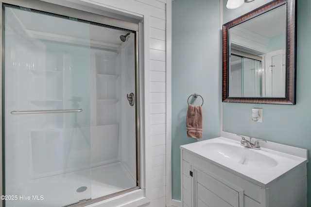 full bathroom with a shower stall and vanity