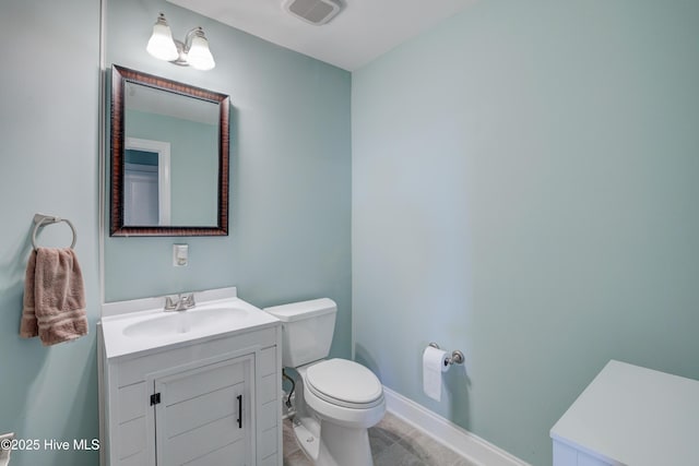 bathroom with visible vents, toilet, vanity, baseboards, and tile patterned floors