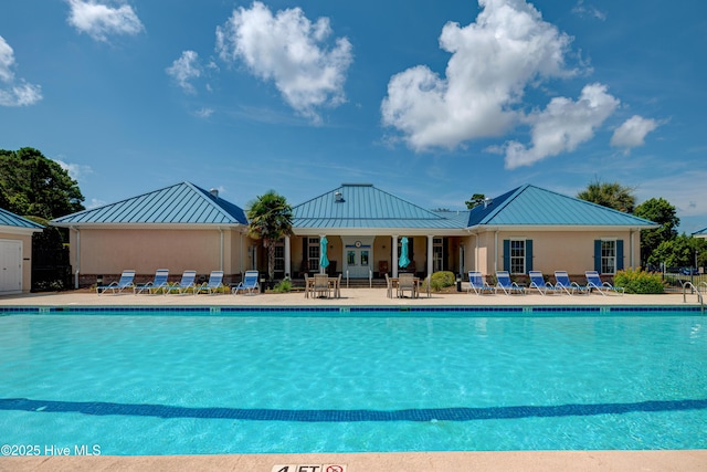 community pool with a patio area