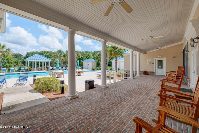 view of patio featuring ceiling fan, a gazebo, and a community pool