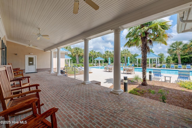 view of patio / terrace with a community pool, a ceiling fan, and a gazebo