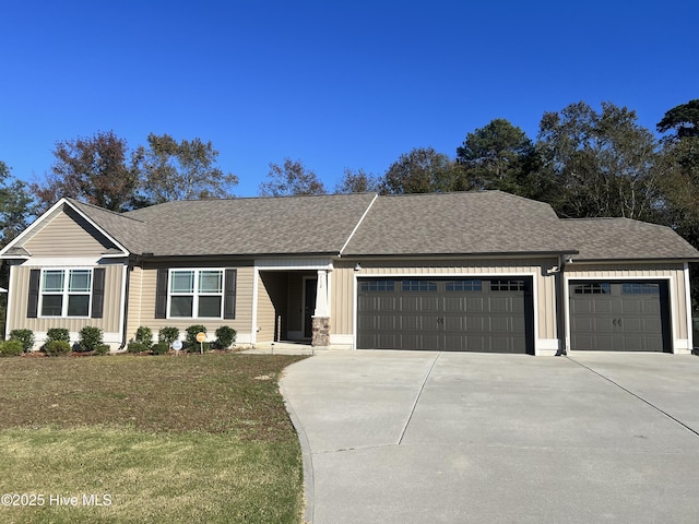 ranch-style home with a garage and a front lawn