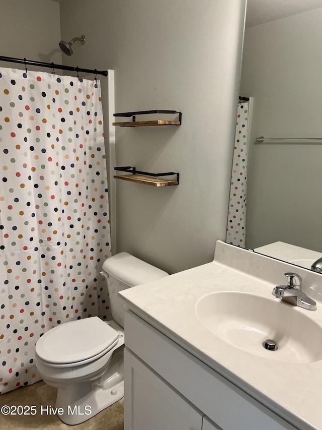 bathroom with tile patterned flooring, vanity, a shower with curtain, and toilet