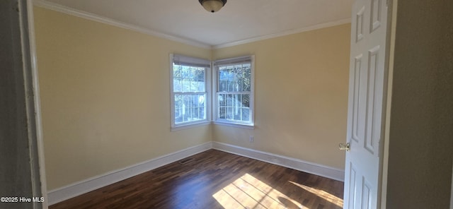 unfurnished room featuring baseboards, dark wood finished floors, and ornamental molding