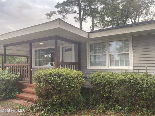 single story home with a carport and a porch