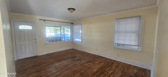 foyer with ornamental molding and dark hardwood / wood-style floors