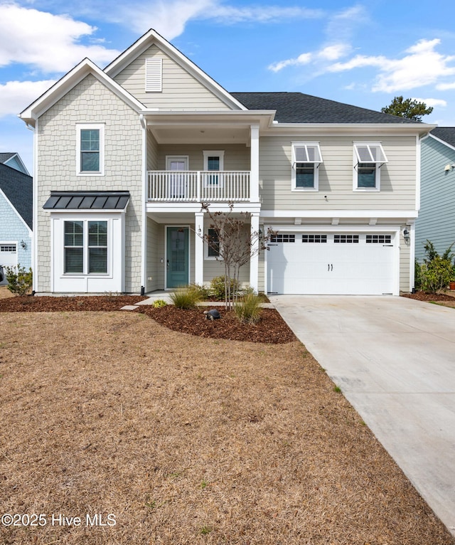 view of front facade featuring an attached garage, concrete driveway, and a balcony