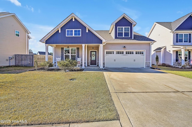 view of front of property with a garage, covered porch, and a front lawn