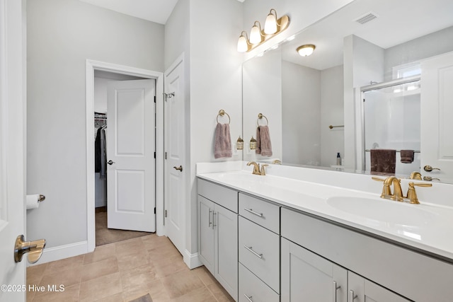 bathroom featuring vanity, tile patterned floors, and a shower with door