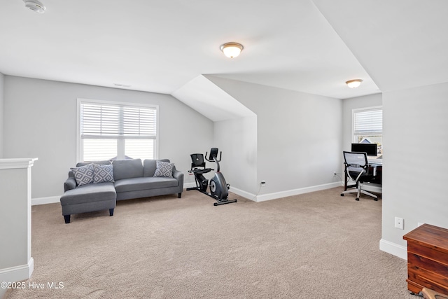 workout room featuring light carpet